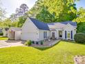 Charming single-story home with attached garage, features manicured lawn and quaint garden at 1715 Colin Creek Ln, Charlotte, NC 28214