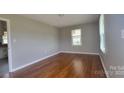 Bright bedroom showcasing beautiful wood flooring and natural light from the window at 2109 Boggs St, Lincolnton, NC 28092