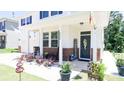 Inviting front porch with rocking chairs, decorative plants, and a welcoming 'hello' sign at 2220 Sussex Rd, York, SC 29745