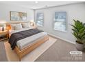 Bright bedroom with a king bed, dual windows, and neutral-toned décor at 250 Marinna Joy Cir, Rockwell, NC 28138