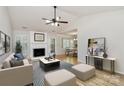 Bright living room features a fireplace, wood floors, a ceiling fan, and a neutral color palette at 2506 Breuster Dr, Charlotte, NC 28210