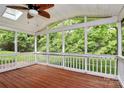 Spacious screened porch with wood flooring and views of the lush greenery outdoors at 2506 Breuster Dr, Charlotte, NC 28210