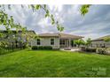 Scenic backyard featuring a well-manicured lawn, covered patio, and neatly trimmed shrubs with a fence at 286 Hemlock Bluff Ct, Denver, NC 28037