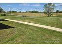 View of the expansive yard and a glimpse of a shed, hinting at outdoor space at 3100 Wallace Rd, Midland, NC 28107