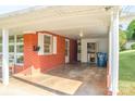 A spacious carport area with brick walls, a window, and an exterior door at 3119 6Th Sw Ave, Hickory, NC 28602