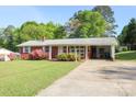 Single-story brick home boasting a covered carport and mature trees at 3119 6Th Sw Ave, Hickory, NC 28602