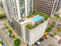 A rooftop pool surrounded by lounge chairs and greenery sits atop a building with parking at 333 W Trade St # 800, Charlotte, NC 28202