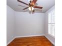 Cozy bedroom with hardwood floors, a ceiling fan, a shuttered window, and neutral walls, offering a blank canvas at 3546 Weddington Oaks Dr, Weddington, NC 28104