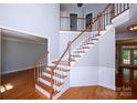 Welcoming two-story foyer with hardwood floors, elegant staircase, and natural light, creating a grand entrance at 3546 Weddington Oaks Dr, Weddington, NC 28104