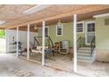Spacious carport area with seating, ceiling fans and steps leading to the house at 400 Houser St, Cherryville, NC 28021