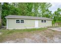 Exterior shot of house showing the backyard, green siding, and white door at 400 Houser St, Cherryville, NC 28021