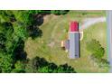 Aerial view of property showing home, large lot, detached garage, and mature trees at 4815 Rifle Range Rd, Conover, NC 28613