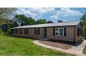 A well-maintained brick ranch home features dark shutters and a walkway to the front door at 4815 Rifle Range Rd, Conover, NC 28613