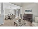 Bright dining room with large windows, elegant lighting, and a cozy piano at 5775 Monticello Nw Dr, Concord, NC 28027