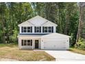 Inviting two-story home features a pristine white facade, black shutters, and a well-maintained front yard at 601 Westway Dr, Gastonia, NC 28054