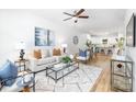 Bright living room featuring hardwood floors, a modern ceiling fan, and comfortable, stylish furniture at 601 Westway Dr, Gastonia, NC 28054