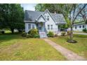 Inviting home with landscaped front yard and covered porch, perfect for enjoying outdoor living at 602 W 6Th St, Newton, NC 28658