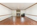 Spacious living room featuring hardwood floors, stone fireplace, and plenty of natural light at 652 Camrose Ne Cir, Concord, NC 28025
