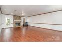 Bright living room features hardwood floors and a stone fireplace, perfect for cozy evenings at 652 Camrose Ne Cir, Concord, NC 28025