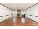Spacious living room featuring hardwood floors, stone fireplace, and plenty of natural light at 652 Camrose Ne Cir, Concord, NC 28025