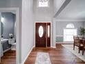 Bright and open foyer with hardwood floors, high ceilings, chandelier, and view of the dining room at 7642 Horseshoe Creek Dr, Huntersville, NC 28078