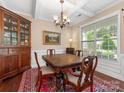 Elegant dining room with a large window, hardwood floors, and a classic chandelier at 79044 Ridgehaven Rd, Lancaster, SC 29720