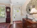 Elegant foyer featuring hardwood floors, a grandfather clock, and a decorative mirror at 79044 Ridgehaven Rd, Lancaster, SC 29720