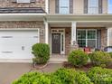Inviting front porch with stone accents, decorative columns, and well-maintained landscaping at 79044 Ridgehaven Rd, Lancaster, SC 29720