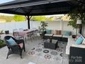 Covered patio area with comfortable seating, an outdoor dining table and privacy fence at 79044 Ridgehaven Rd, Lancaster, SC 29720