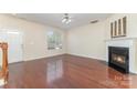 Open living room featuring hardwood floors, fireplace, and plenty of natural light at 827 Gentlewinds Ct, Fort Mill, SC 29708