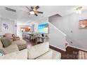 Bright living area with a large television, open layout, and staircase in view at 8814 Gerren Ct, Charlotte, NC 28217