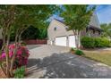 Spacious driveway leading to a two-car garage, surrounded by lush greenery at 900 Springwood Dr, Waxhaw, NC 28173