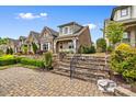 Beautiful homes line the street with mature landscaping and inviting curb appeal at 9319 Highclere Ct, Matthews, NC 28105