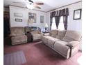 Comfortable living room with a relaxing atmosphere, plush seating, and ample lighting at 103 Riding Rd, Mount Holly, NC 28120