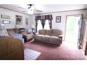 Spacious living room with comfortable seating, natural light, and a ceiling fan at 103 Riding Rd, Mount Holly, NC 28120