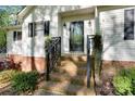 Inviting front entrance with brick steps, complemented by black railings and door accents at 118 Taylor Ct # 16, Mooresville, NC 28117