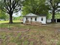 Quaint single-story home with front yard, front ramp, and lush greenery surrounding the property at 135 Hendren Ln, Hiddenite, NC 28636