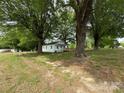 Beautiful home surrounded by mature trees, with a spacious yard and convenient front ramp at 135 Hendren Ln, Hiddenite, NC 28636