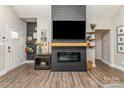 Cozy living room featuring hardwood floors, a modern fireplace, and a large mounted television at 135 Westerwood Dr, Rock Hill, SC 29732