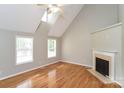 Bright living room with vaulted ceiling, wood floors, a fireplace, and abundant natural light at 1930 Manning Pl, Rock Hill, SC 29730