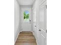 Bright entryway featuring a white door with glass, light wood floors, and white walls at 2009 Vinyasa Ln # Sts-44, Charlotte, NC 28215