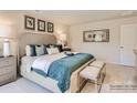 Beautiful bedroom with plush bedding, accent pillows, stylish art, and and benches at 2106 Columbidae Ln, Gastonia, NC 28052