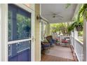 Inviting front porch with comfortable seating, ferns, and a ceiling fan at 2306 Club Rd, Charlotte, NC 28205