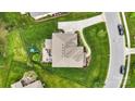 Aerial view of a backyard with green grass, a patio area, a play area, and a fenced perimeter at 2655 Stonewood Vw, Kannapolis, NC 28081