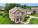 Charming two-story brick home with a welcoming front porch, lovely landscaping, and a well-maintained lawn at 2655 Stonewood Vw, Kannapolis, NC 28081