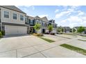 Street view of townhomes with well-maintained landscaping and ample parking space, complemented by beautiful blue skies at 314 Embers Ln, Clover, SC 29710