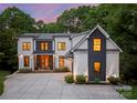 Stunning two-story home features a modern design, well-manicured landscaping, and a spacious driveway for easy parking at 3933 Ayrshire Pl, Charlotte, NC 28210