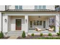 Inviting covered front porch with stylish seating and elegant brickwork at 4021 Nettie Ct # 7, Charlotte, NC 28211