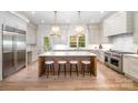 Well-lit kitchen featuring a large island, pendant lighting, and modern appliances at 4021 Nettie Ct # 7, Charlotte, NC 28211
