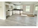 Bright kitchen features white cabinets, black countertops, stainless appliances and wood grain flooring at 4044 Hurley Walters Rd, Lancaster, SC 29720